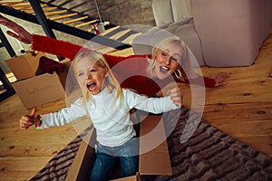 Emotional blonde woman playing with her kid