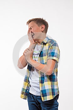 Emotional boy in a plaid shirt