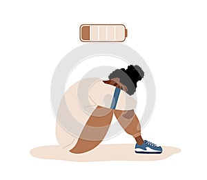 Emotional burnout. Sad african teenager with low battery sitting on floor and crying. Mental health problem. Deadline