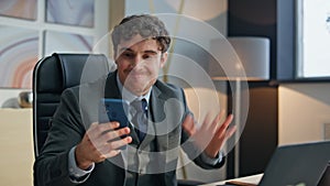 Emotional ceo checking sms gesturing at office closeup. Stressed businessman