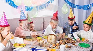 Emotional children having dinner to birthday