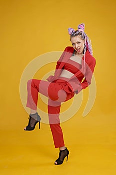 Emotional cocky model, bold person in studio on yellow background. Daring woman