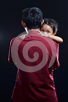 Emotional concept photo on studio. Asian father carrying his child