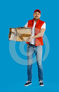 Emotional courier with cardboard box on blue background. Poor quality delivery service