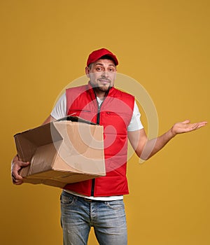 Emotional courier with damaged cardboard box on background. Poor quality delivery service