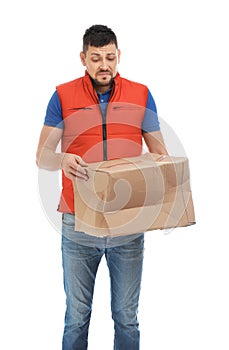 Emotional courier with damaged cardboard box on background. Poor quality delivery service