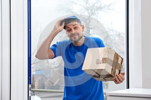 Emotional courier with damaged cardboard box . Poor quality delivery service
