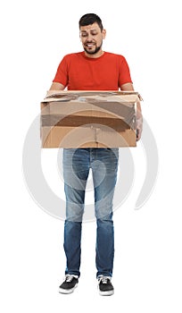 Emotional courier with damaged cardboard box on background. Poor quality delivery service