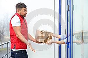 Emotional courier giving damaged cardboard box to client. Poor quality delivery service