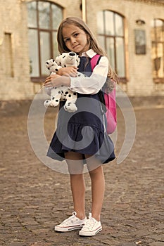 Emotional development. Little child cuddle toy dog outdoors. Toy friend. Childhood friend. Preschool and playschool