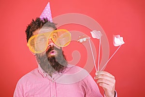 Emotional diversity concept. Hipster in giant sunglasses celebrating. Man with beard on cheerful face holds smiling lips