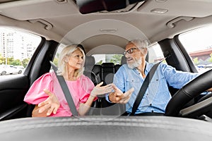 Emotional elderly couple having conflict in car