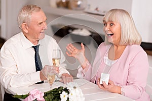 Emotional elderly lady excited about proposal