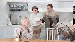 Emotional family quarrel, man and woman blaming old woman. Family quarrel of three people