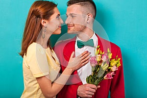 Emotional fashion couple give each other flowers on Valentine`s
