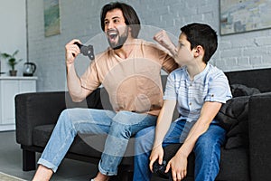 emotional father and son playing video games together