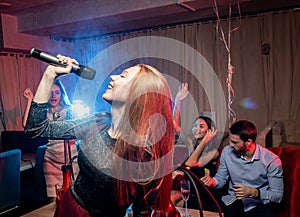 Emotional female singer in karaoke bar