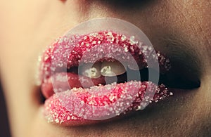 Emotional girl with a lollipop over pink background