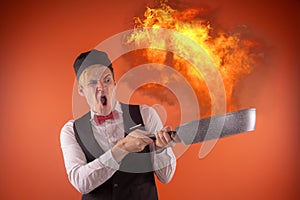 Emotional guy holding a frying pan in his hands, on an orange background.