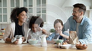 Emotional happy mixed race family preparing weekend breakfast at home. photo