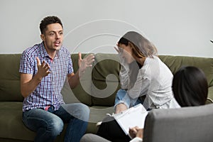 Emotional husband speaking to psychologist while offended wife s