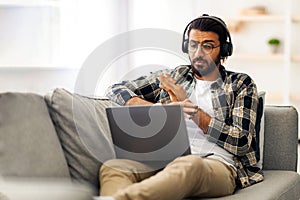 Emotional indian guy having video call with partner