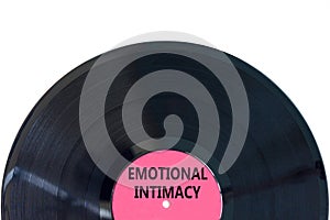 Emotional intimacy symbol. Concept words Emotional intimacy on beautiful black vinyl disk. Beautiful white table white background photo