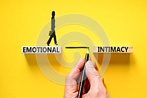 Emotional intimacy symbol. Concept words Emotional intimacy on beautiful wooden blocks. Psychologist icon. Beautiful yellow table photo