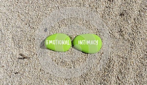 Emotional intimacy symbol. Concept words Emotional intimacy on beautiful green stone. Beautiful sand beach background. Psychology photo