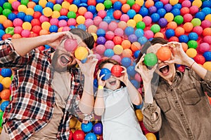 Emotional little child have fun with his parents.