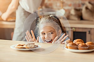 Emotional little girl looking with desire at sweets