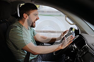 Emotional man in car. Aggressive driving