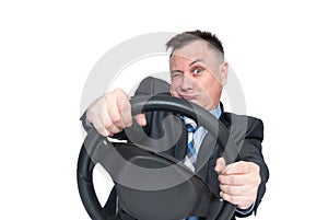 Emotional man in a dark jacket is reckless on the road while making a turn while holding a car steering wheel. Isolated on white photo