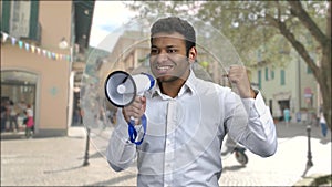 Emotional man making anouncement through megaphone.