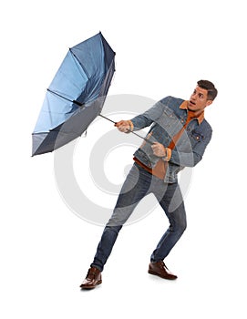 Emotional man with umbrella caught in gust of wind on white background