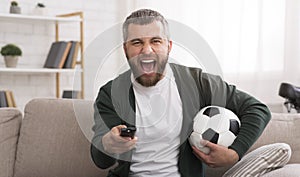 Emotional man watching football game on TV