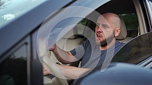 Emotional millennial man driving a car, eating burger, had an accident. Sad driver stuck in traffic. Transportation