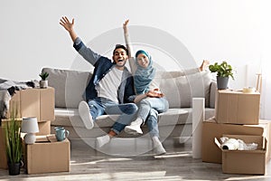 Emotional muslim family celebrating moving to their new house