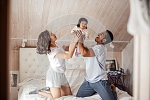 Emotional parents spending happy time with the baby girl