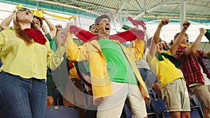 Emotional people, loud sport fans on stadium, attending soccer match and cheering up favorite team during game