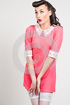 Emotional pin-up girl in coral dress
