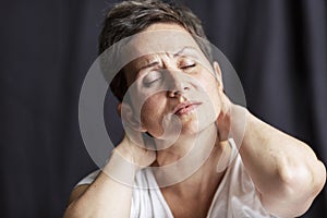 Emotional portrait of an adult woman with short hair and closed eyes. Close-up. Black background