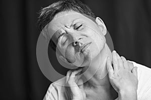 Emotional portrait of an adult woman with short hair and closed eyes. Close-up. Black and white