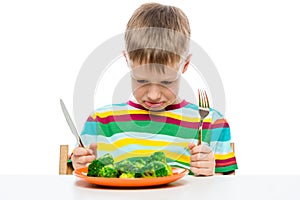 emotional portrait of a boy who doesn`t like to eat broccoli, shooting