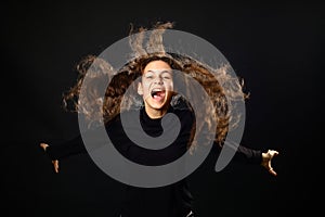 Emotional portrait of a girl with long curly hair on background