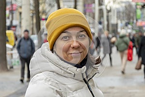 Emotional portrait of a laughing woman 40-45 years old, looking at the camera, street portrait.