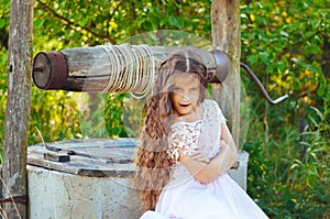 Emotional portrait of a little girl with long hair, summer day