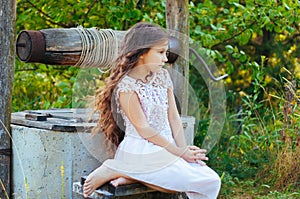 Emotional portrait of a little girl with long hair, summer day