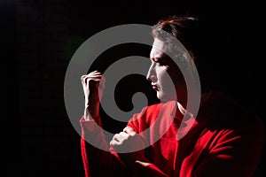 Emotional portrait of middle age woman on black background. Female model gets angry while posing in the Studio