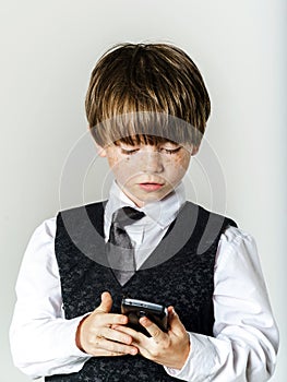 Emotional red-haired boy with mobile phone